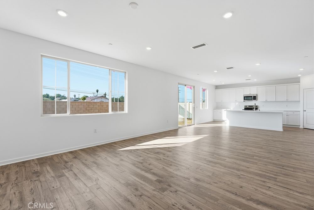 9575 Silverstein Drive Riverside, CA 92508 - Photo 4 of 22 a view of an empty room with wooden floor and a window