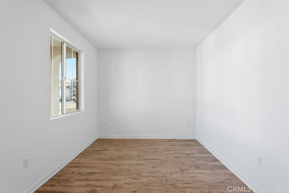 9575 Silverstein Drive Riverside, CA 92508 - Photo 6 of 22 a view of an empty room with wooden floor and a window