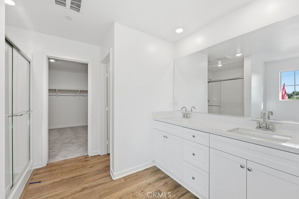 9575 Silverstein Drive Riverside, CA 92508 - Photo 7 of 22 a bathroom with a double vanity sink and mirror