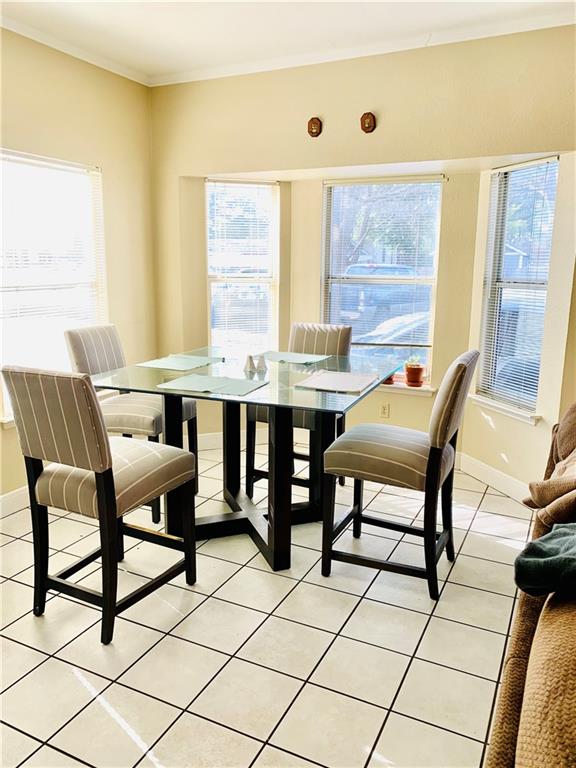 503 East 38th Street, Unit B Austin, TX 78705 - Photo 7 of 11 Dining space with ornamental molding and light tile patterned flooring