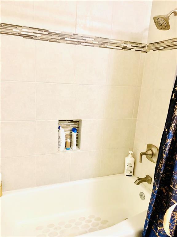 503 East 38th Street, Unit B Austin, TX 78705 - Photo 10 of 11 Bathroom with shower / bath combination with curtain