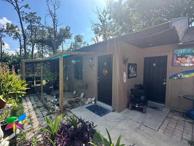 a backyard of a house with lots of green space and seating area