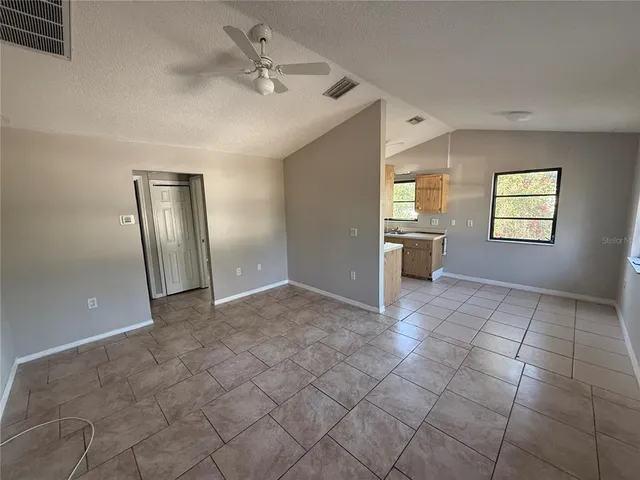 a kitchen with a stove a refrigerator and cabinets