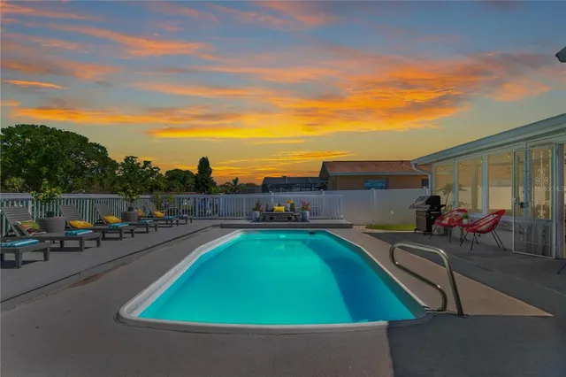 a view of a swimming pool with chairs