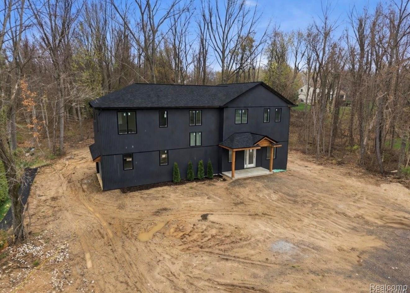 11810 Scenic Valley Road Davisburg, MI 48350 - Photo 31 of 46 Contemporary dark-paneled exterior with a black shingle roof