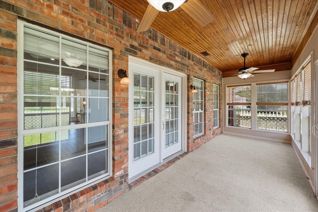 13021 Rudy's Way Streetman, TX 75859 - Photo 30 of 40 Sunroom near Corsicana with brick accents, ceiling fans, and bright windows for relaxing year-round.