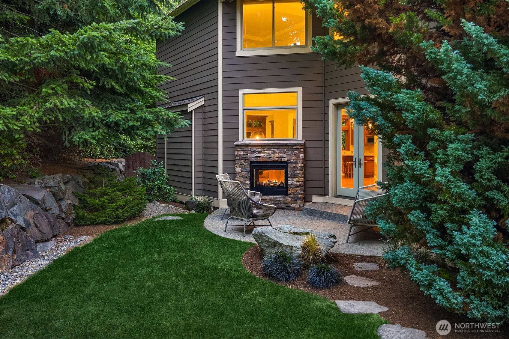 2989 Northeast Davis Loop Issaquah, WA 98029 - Photo 38 of 40 a view of a brick house with a yard plants and a large tree