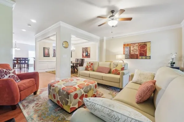 a living room with furniture and a chandelier