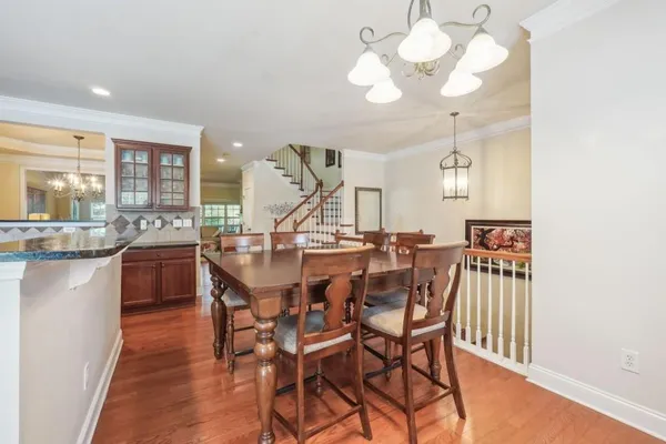 a view of a dining room with furniture and wooden floor