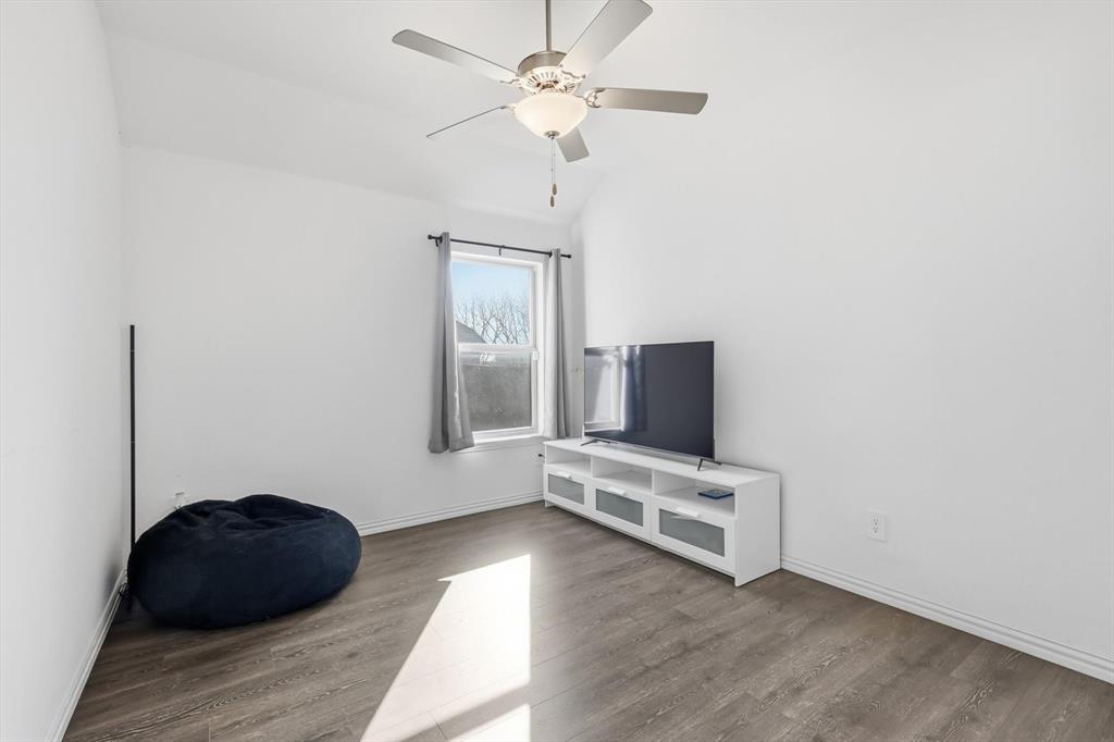 7508 Rhyner Way Fort Worth, TX 76137 - Photo 18 of 23 Secondary bedroom with ceiling fan.
