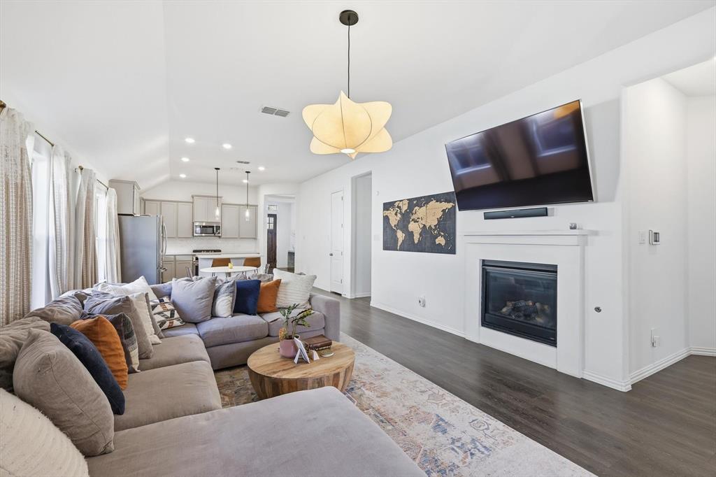 7508 Rhyner Way Fort Worth, TX 76137 - Photo 10 of 23 Decorative lighting and fireplace with gas logs.