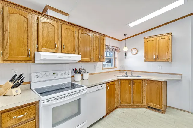 a kitchen with a sink cabinets and appliances