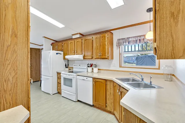 a kitchen with a sink cabinets and a window