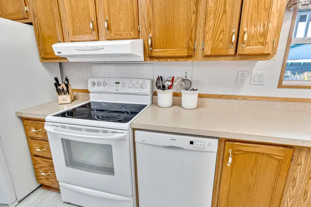 a kitchen with a stove and a refrigerator