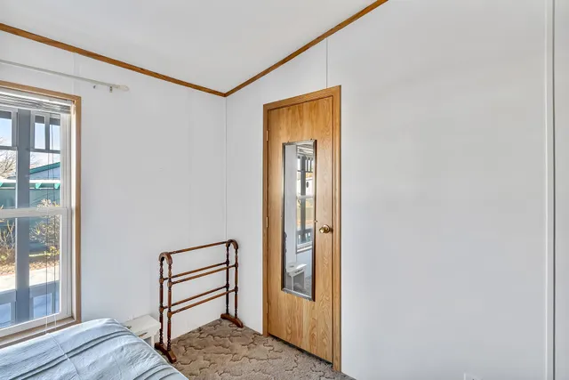 a view of a hallway with wooden floor and entryway