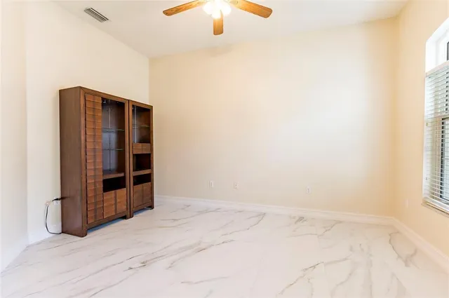 a view of wooden floor and windows in a room