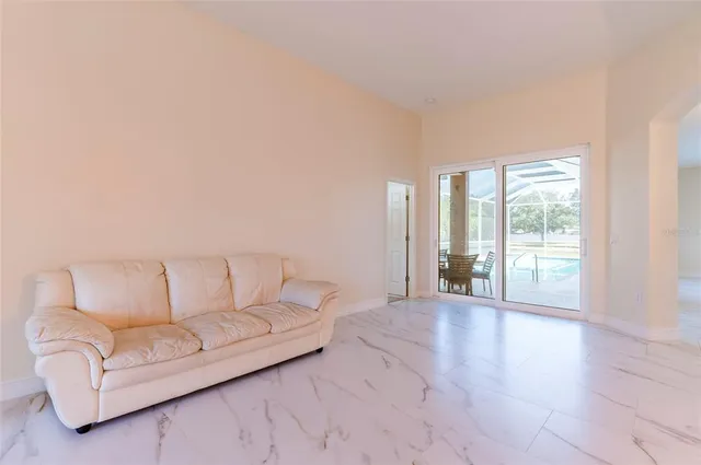 a living room with furniture and large windows