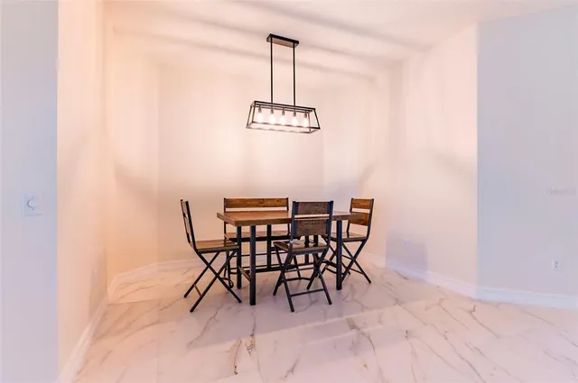 a view of a dining room with a table and chairs