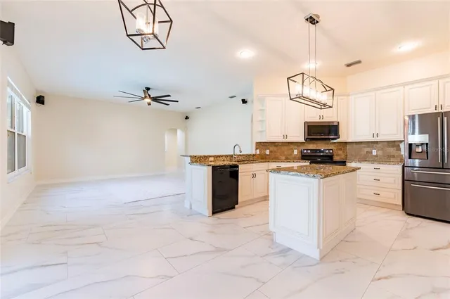 a kitchen with cabinets and stainless steel appliances