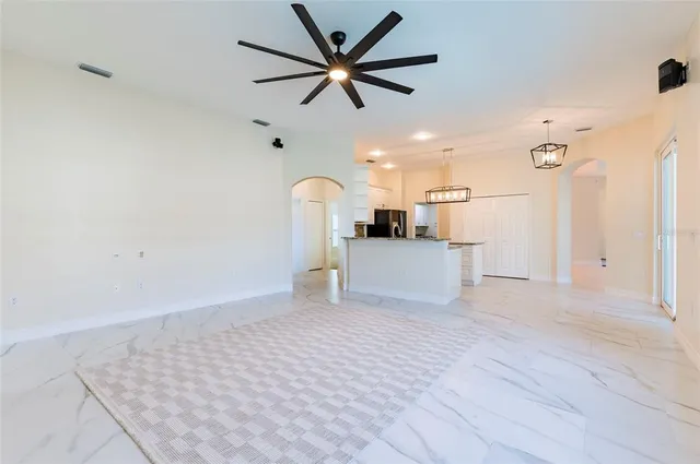 a bathroom with a granite countertop toilet sink and mirror