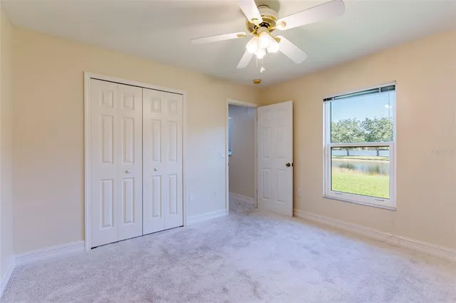 a bedroom with a bed and ceiling fan