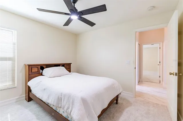 a bathroom with a granite countertop sink a toilet and a mirror