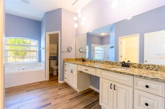 a bathroom with a bathtub and a window