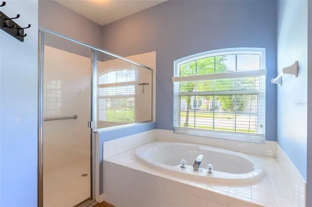 a dining room with furniture a chandelier and wooden floor