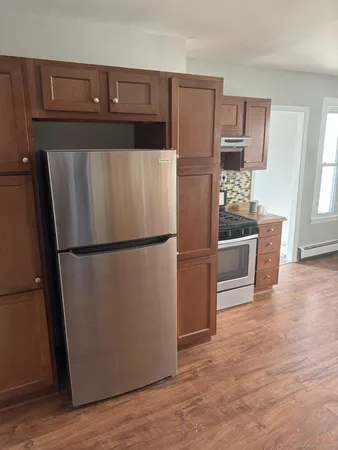 a kitchen with stainless steel appliances a refrigerator and a stove