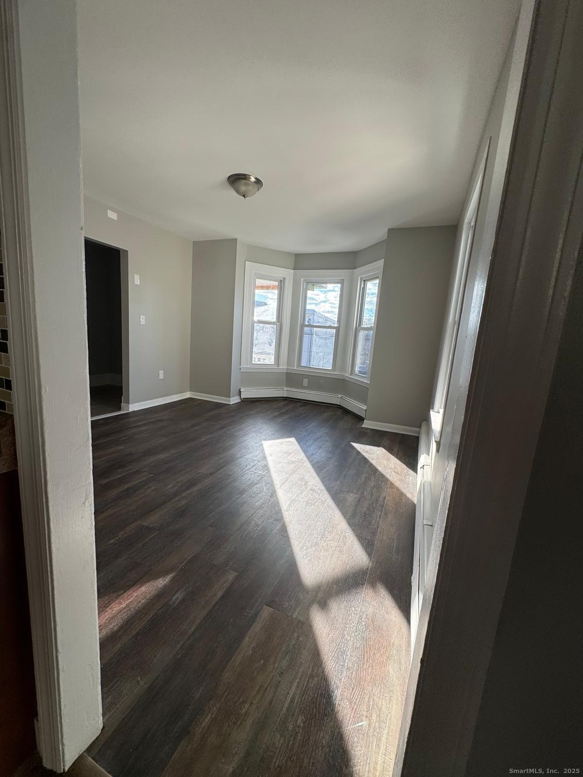422 Lafayette Street, Unit 1R Bridgeport, CT 06604 - Photo 3 of 15 wooden floor in an empty room with a window