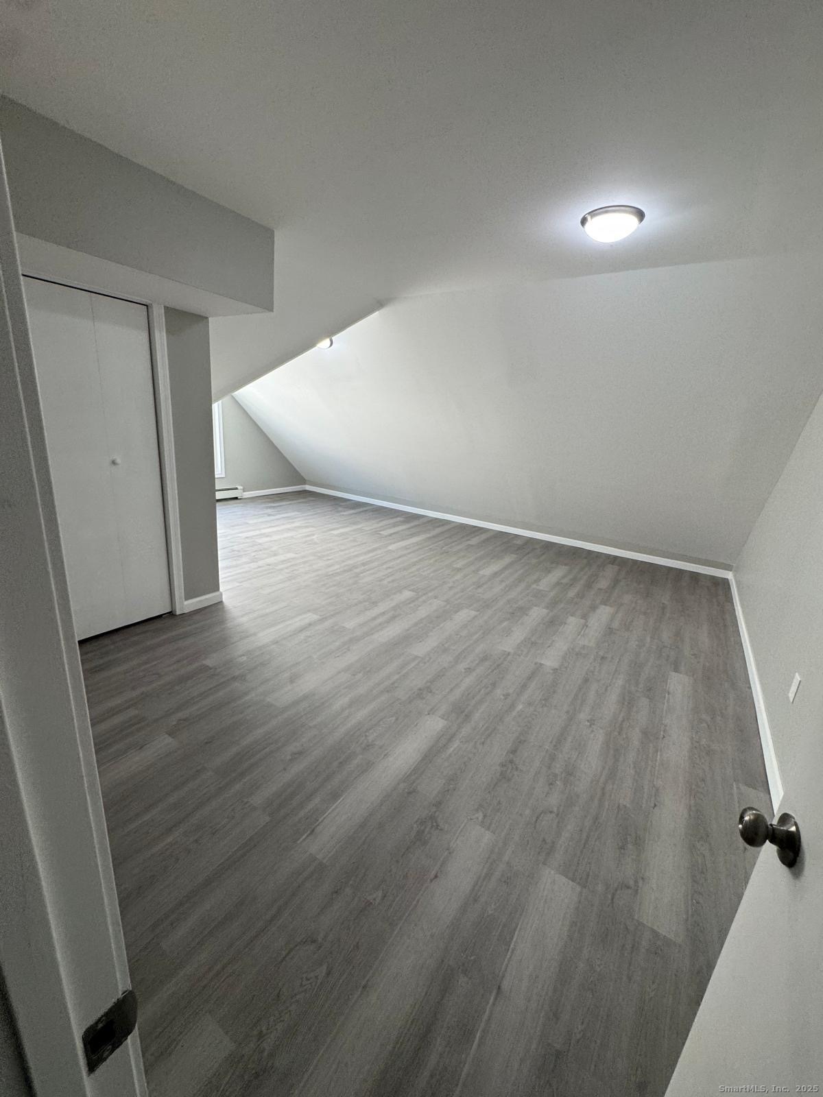 422 Lafayette Street, Unit 1R Bridgeport, CT 06604 - Photo 6 of 15 a view of an empty room and wooden floor
