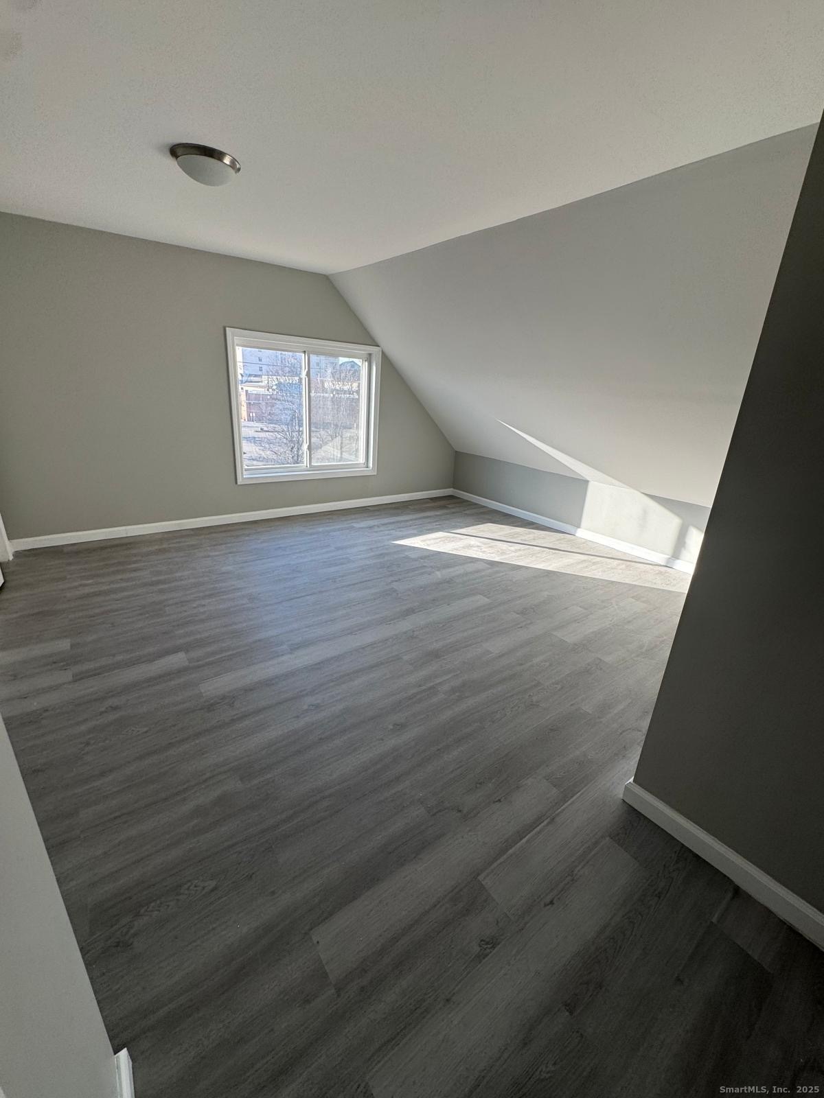 422 Lafayette Street, Unit 1R Bridgeport, CT 06604 - Photo 9 of 15 wooden floor in an empty room with a window