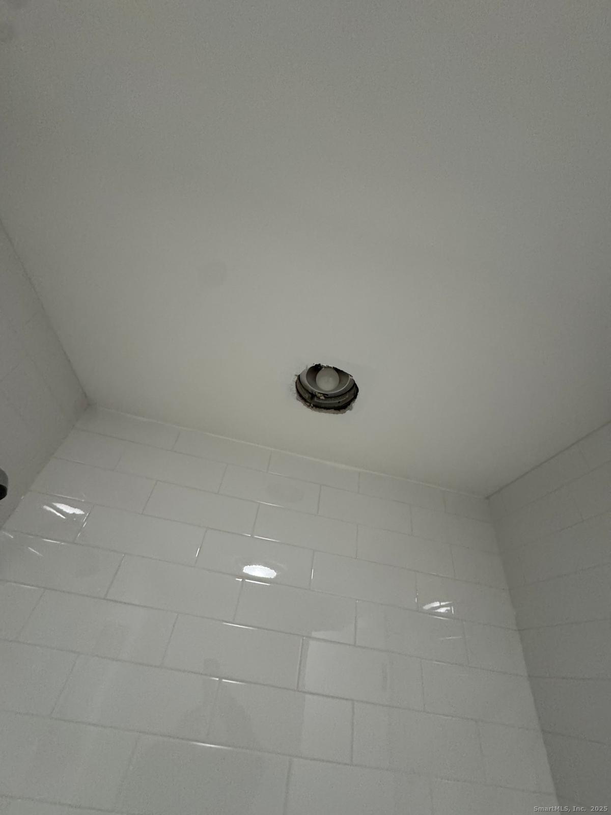 422 Lafayette Street, Unit 1R Bridgeport, CT 06604 - Photo 10 of 15 a view of a refrigerator in a white wall