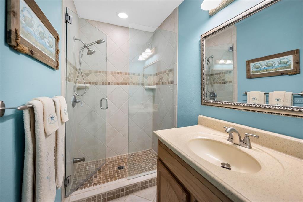 13303 Gulf Lane Madeira Beach, FL 33708 - Photo 28 of 42 a bathroom with a sink and a mirror