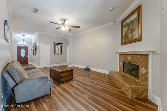 a view of a room with wooden floor and white walls