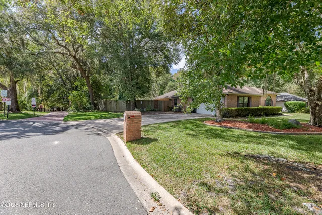 a view of a room with wooden floor and large window
