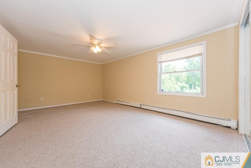1518 Englishtown Road Old Bridge, NJ 08857 - Photo 15 of 25 an empty room with a window and a ceiling fan