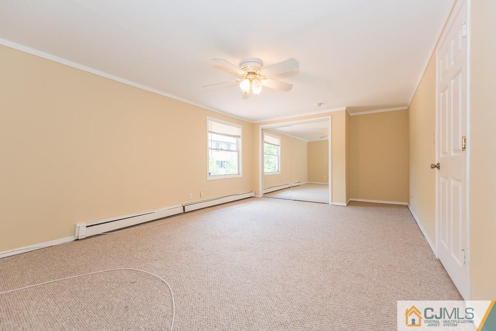 1518 Englishtown Road Old Bridge, NJ 08857 - Photo 16 of 25 an empty room with windows and fan