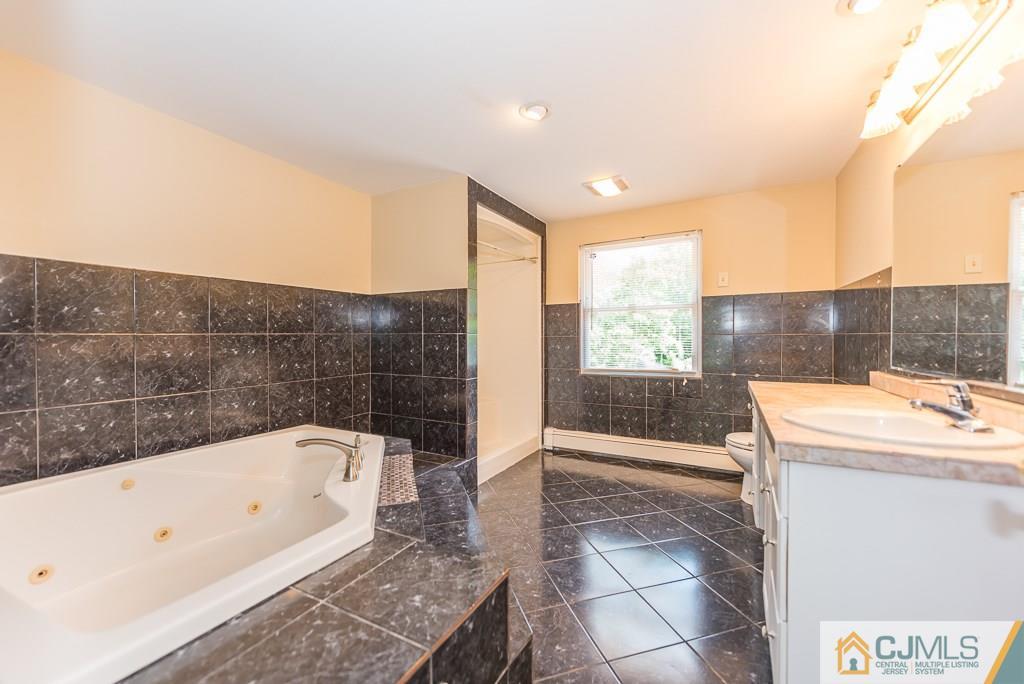 1518 Englishtown Road Old Bridge, NJ 08857 - Photo 20 of 25 a bathroom with a bathtub and a shower