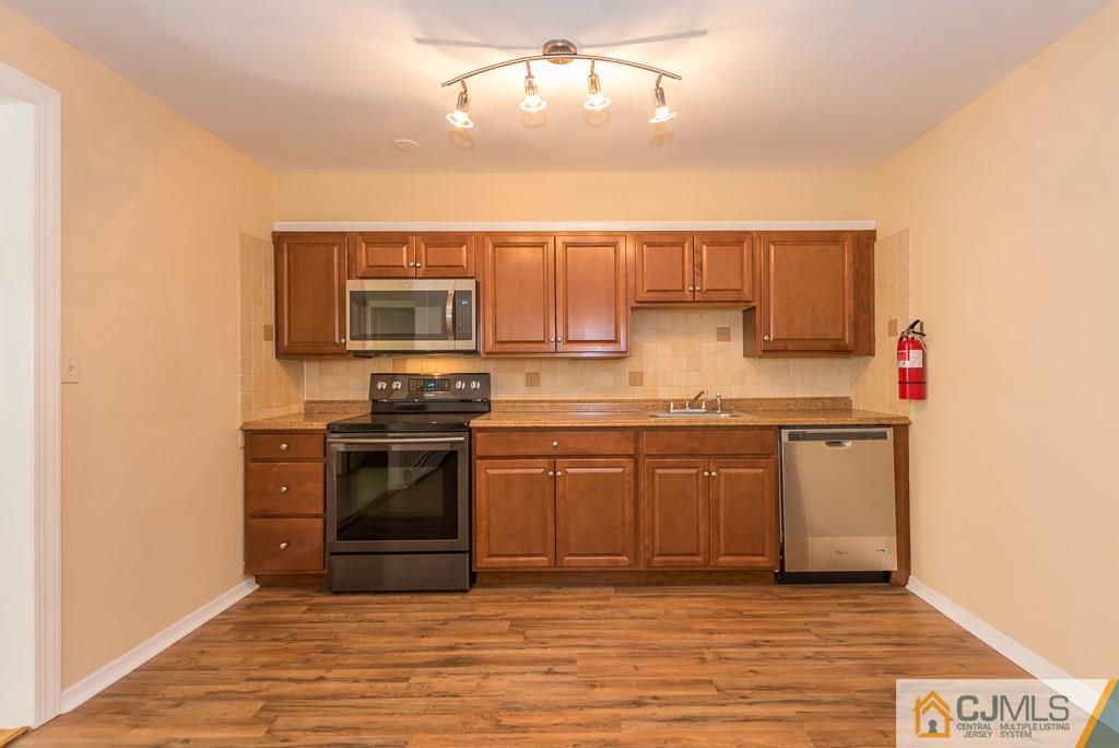 1518 Englishtown Road Old Bridge, NJ 08857 - Photo 6 of 25 a kitchen with stainless steel appliances granite countertop a stove and a sink