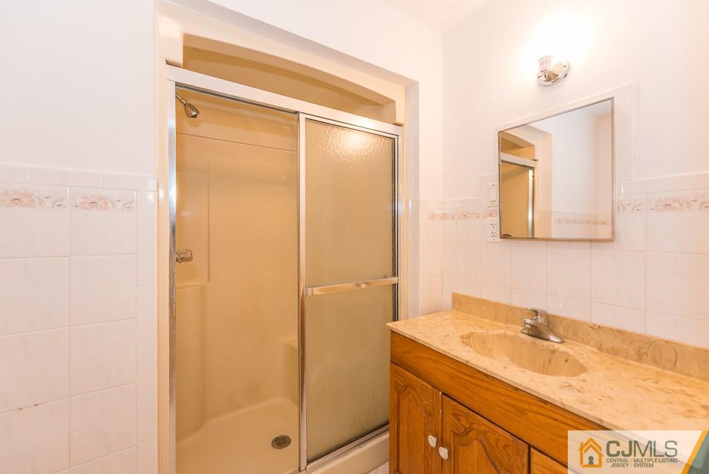 1518 Englishtown Road Old Bridge, NJ 08857 - Photo 10 of 25 a bathroom with a sink and a mirror