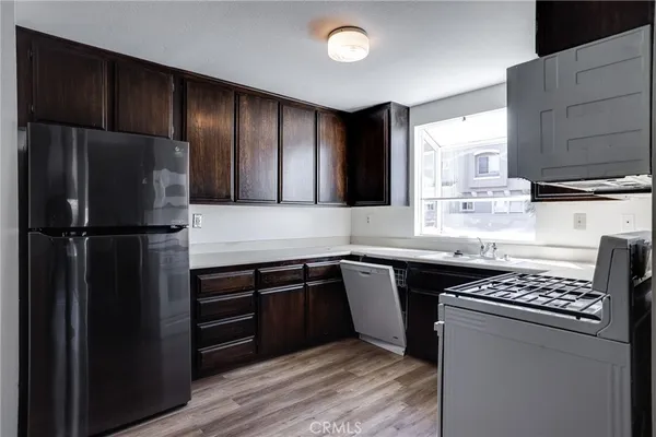 a kitchen with stainless steel appliances granite countertop a refrigerator and a stove