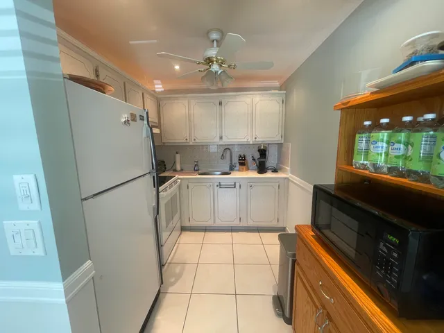 a kitchen with a refrigerator a sink and cabinets