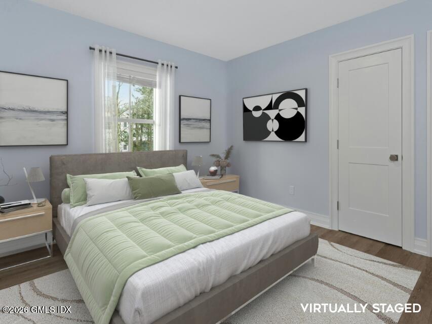 104 Pemberwick Road, Unit 1 Greenwich, CT 06831 - Photo 14 of 18 a bedroom with a bed and a window
