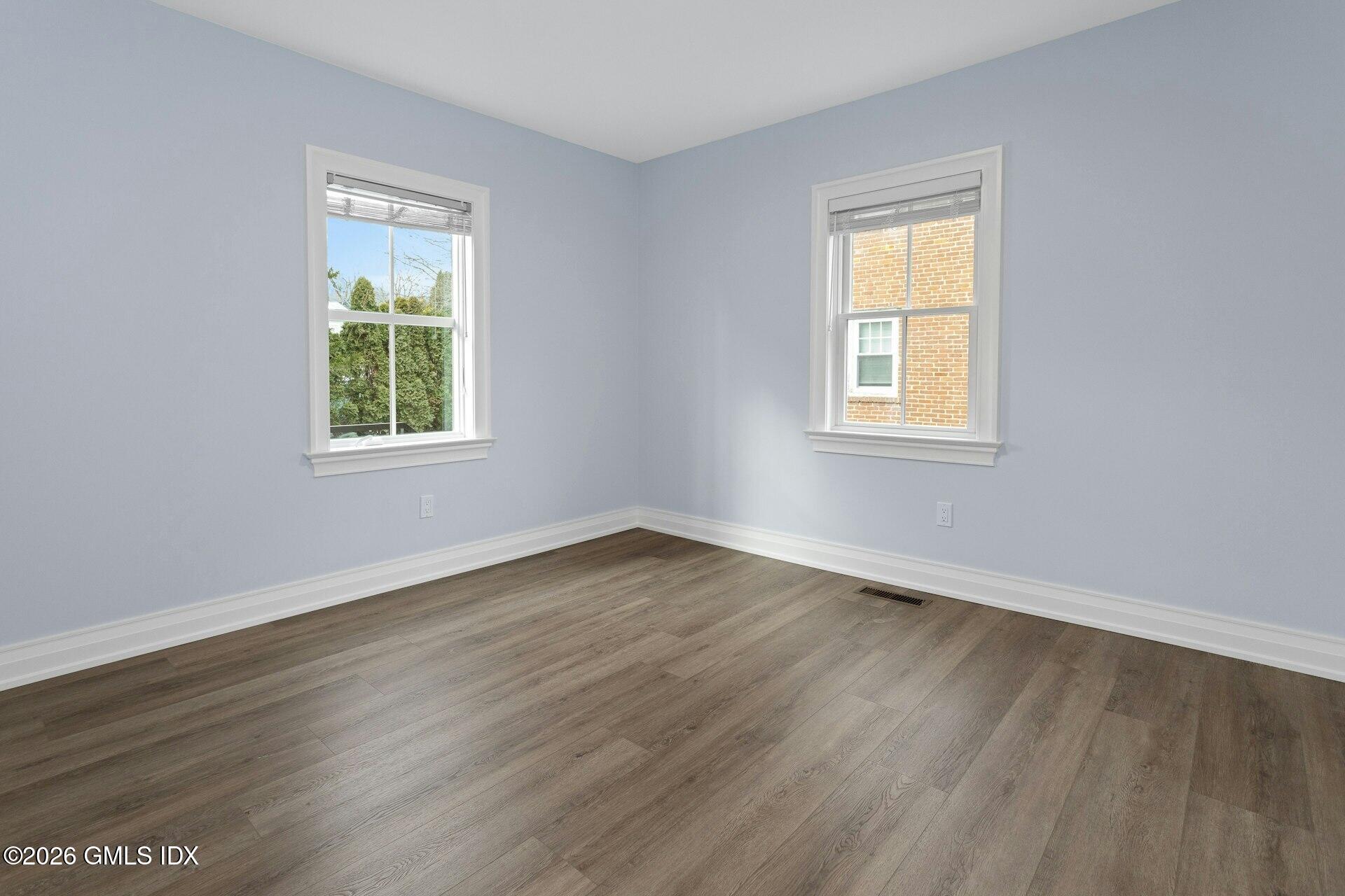 104 Pemberwick Road, Unit 1 Greenwich, CT 06831 - Photo 16 of 18 an empty room with wooden floor and a window