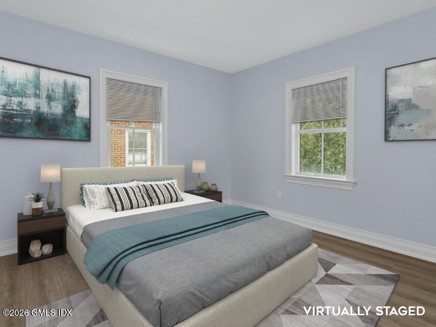 104 Pemberwick Road, Unit 1 Greenwich, CT 06831 - Photo 17 of 18 a bedroom with a bed and a window