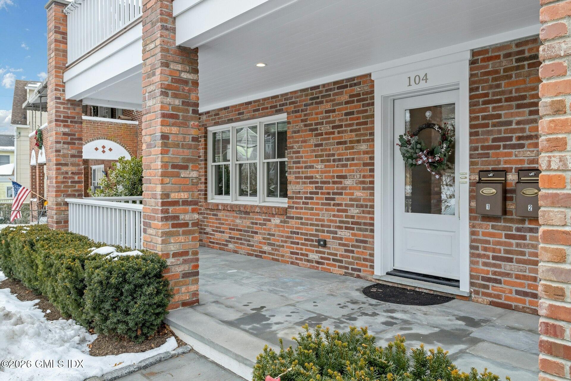104 Pemberwick Road, Unit 1 Greenwich, CT 06831 - Photo 2 of 18 a view of a brick house with a large windows