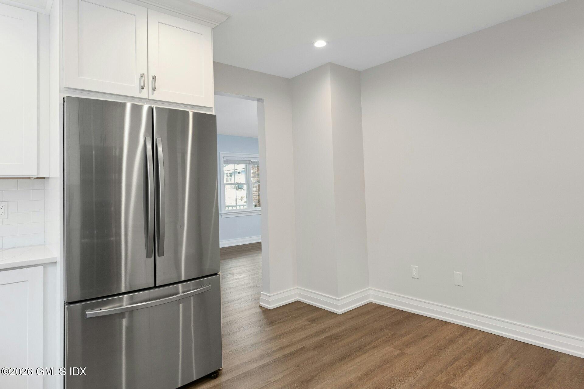 104 Pemberwick Road, Unit 1 Greenwich, CT 06831 - Photo 5 of 18 a view of empty room with wooden floor and window