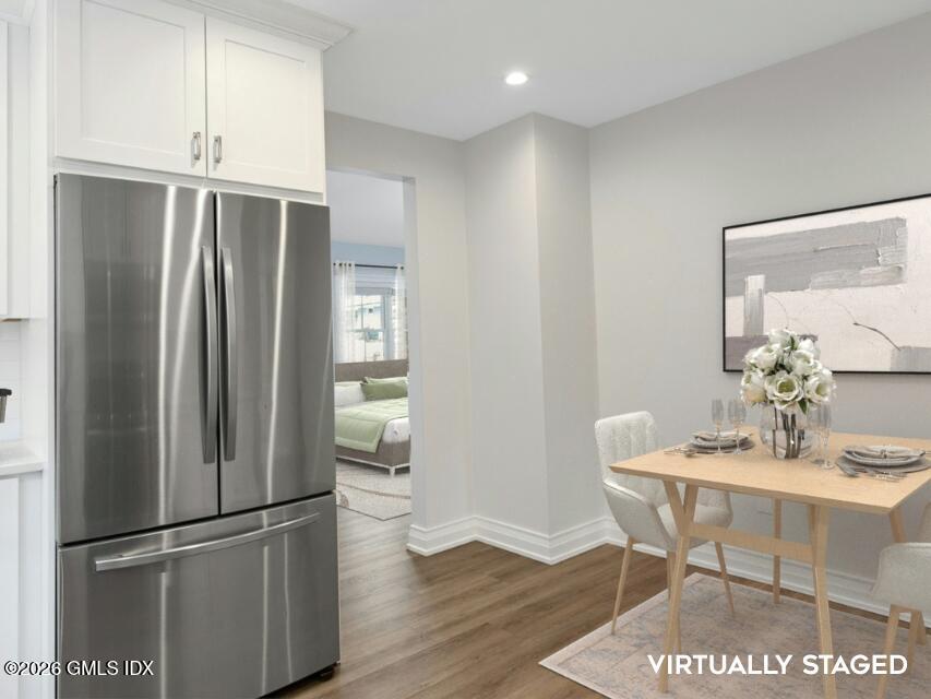 104 Pemberwick Road, Unit 1 Greenwich, CT 06831 - Photo 6 of 18 a kitchen with stainless steel appliances refrigerator dining table and chairs