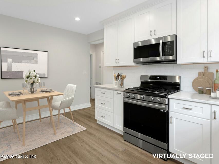 104 Pemberwick Road, Unit 1 Greenwich, CT 06831 - Photo 9 of 18 a kitchen with stainless steel appliances a stove a sink and a microwave